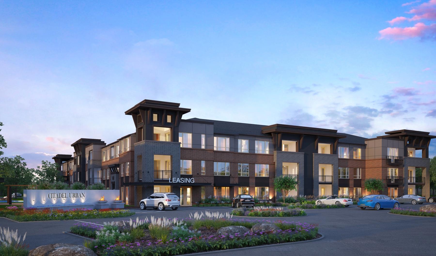 View of Citadel Urban apartment complex in San Antonio, TX, featuring the leasing office, parking lot, and landscaping